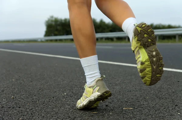 stock image Sneakers on the jogging girl close-up.