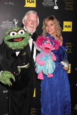 Caroll Spinney, left, and Leslie Carrara Rudolph pose with puppe clipart