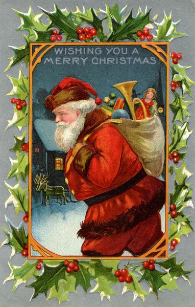 サンタ クロースと贈り物の完全な袋のビンテージのクリスマス カード ストック画像