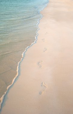 FOOTPRINTS ON THE BEACH SAND clipart