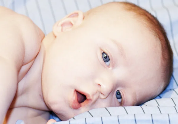 Baby boy with blue eyes looking at the camera — Stock Photo, Image