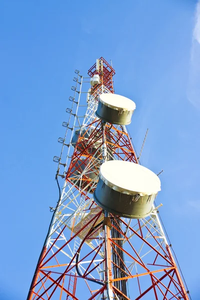 Telecommunication tower with antennas a blue sky. Stock Photo