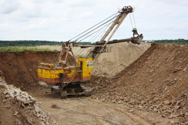 Excavator in an oil shale mine clipart