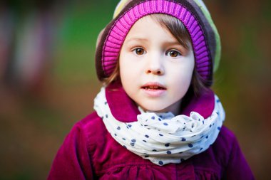 Beautiful smiling small girl in beret outdoor in the park clipart