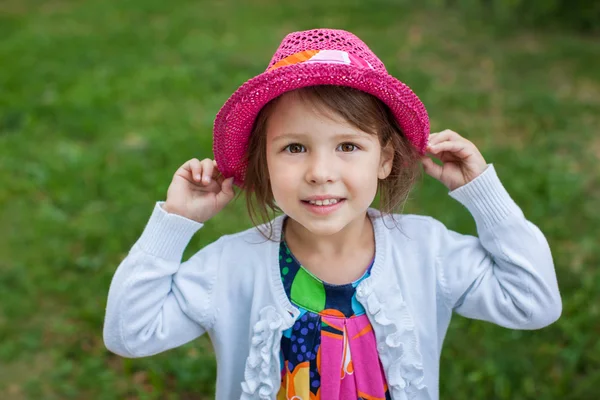 Adorable toddler girl in red hat — Stock Photo, Image