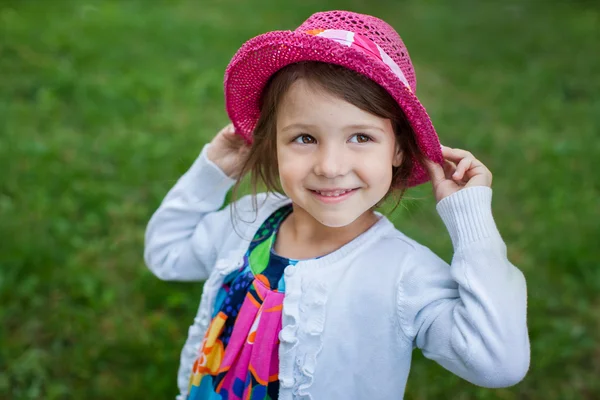 Adorable toddler girl in red hat — Stock Photo, Image