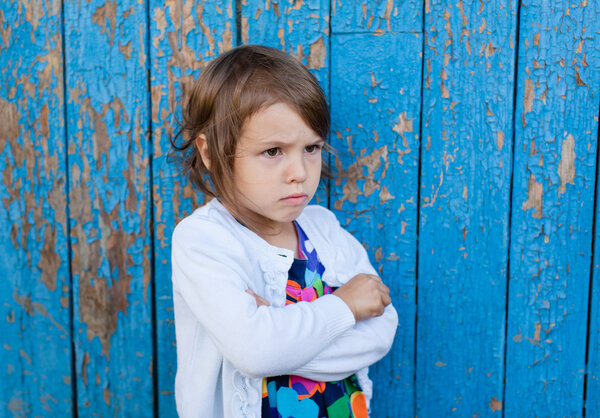 Outdoor portrait of angry little girl