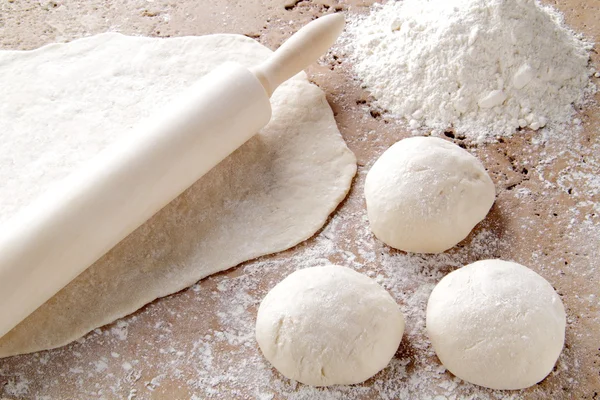 stock image Dough for the preparation of home-made pizza on the table