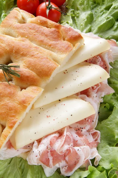 Closeup focaccia whit bacon end cheese on the green salad — Stock Photo, Image