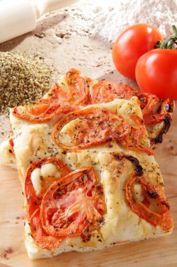 Pizza focaccia whit tomato on the stone table clipart