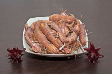 Dish with crustaceans and hibiscus clipart