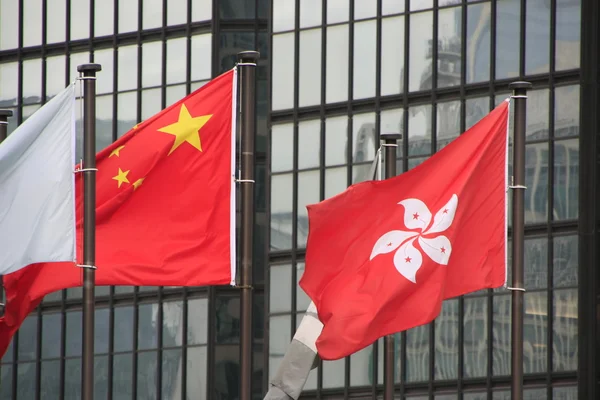 Flags of China and Hong Kong blowing on poles