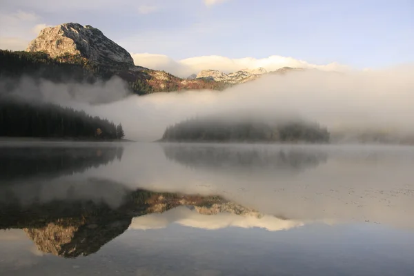 stock image Morning mist over lake and mountains