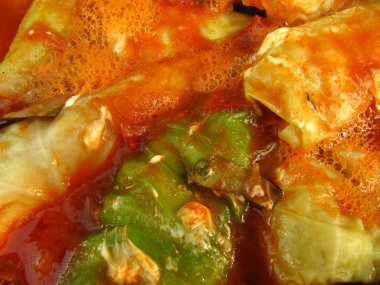 Stuffed cabbage in sauce close up clipart