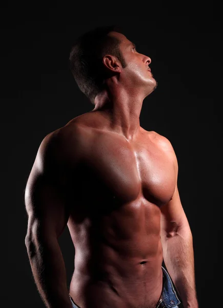 Muscular man from below against the — Stock Photo, Image