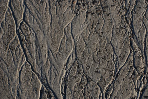 Lama texturizada na margem do rio Imagem De Stock