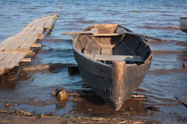 Wood boat near the bank clipart