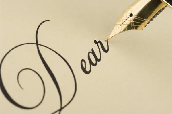 Inscription Dear with gold pen — Stock Photo, Image