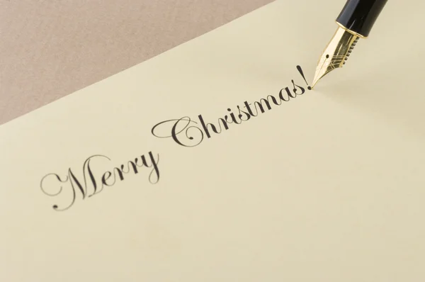 Napis Wesołych Świąt z złote pióro — Zdjęcie stockowe
