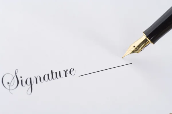 Gold pen on a paper — Stock Photo, Image