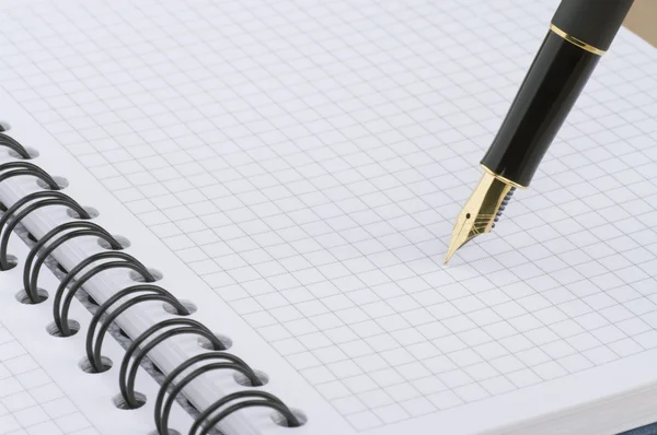 Notebook with gold pen — Zdjęcie stockowe