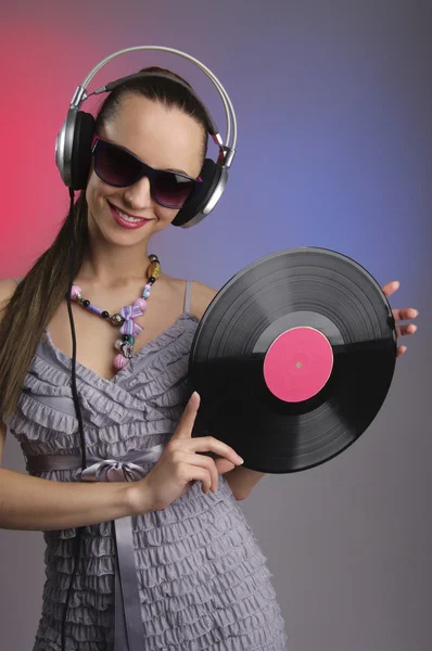 Emotional brunette in headphones with vinyl record — Stock Photo, Image
