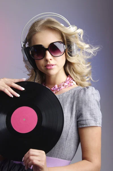Emotional blonde in headphones with vinyl record — Stock Photo, Image
