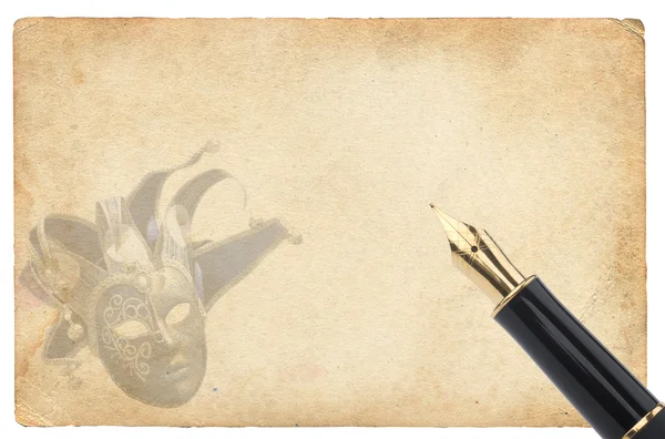 Золотая ручка на бумаге с маской — стоковое фото
