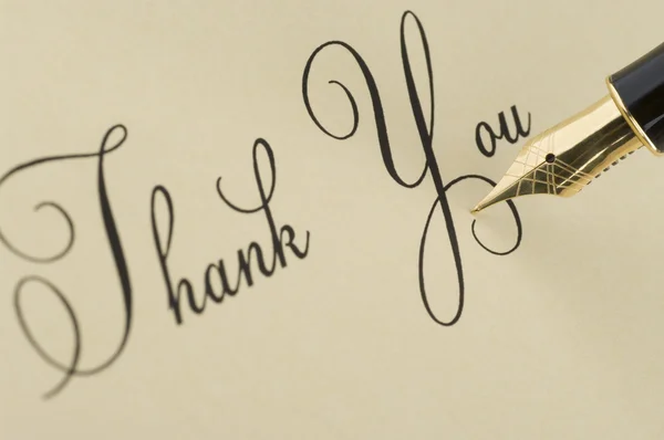 Inscription Thank you with gold pen Royalty Free Stock Photos