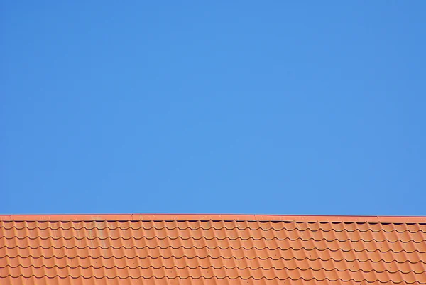 stock image Red roof and sky