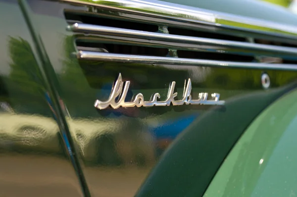 stock image PAAREN IM GLIEN, GERMANY - MAY 26: The emblem of the Soviet post-war car Moskvitch 400, 