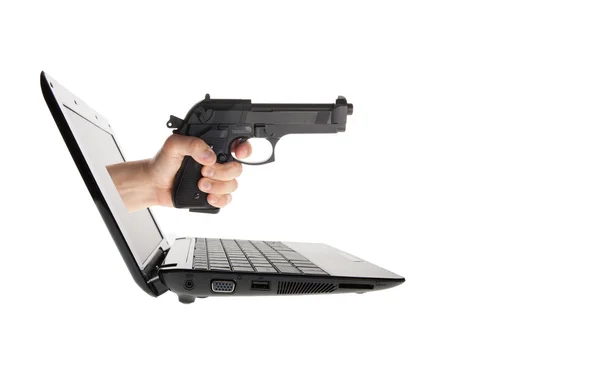 Laptop e mão com arma saindo isolado no branco — Fotografia de Stock