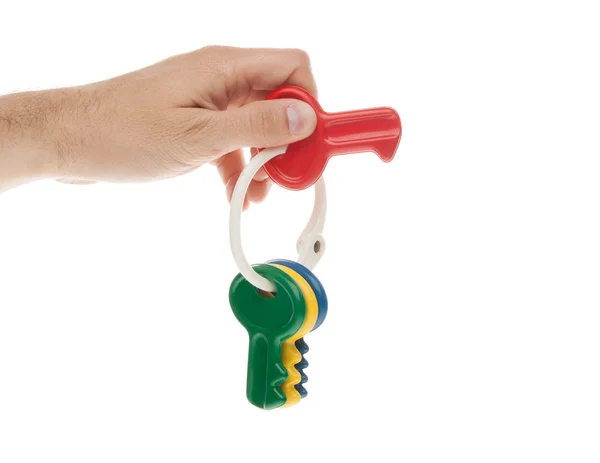 Mão segurando chave de plástico vermelho — Fotografia de Stock
