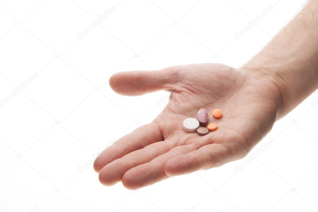 Hand holding or offering pills