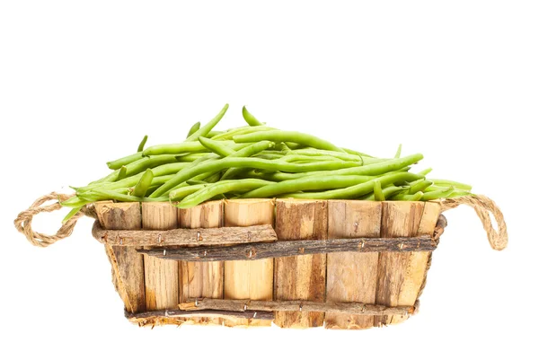 Bunch of green beans in a wooden basket — Stock Photo, Image