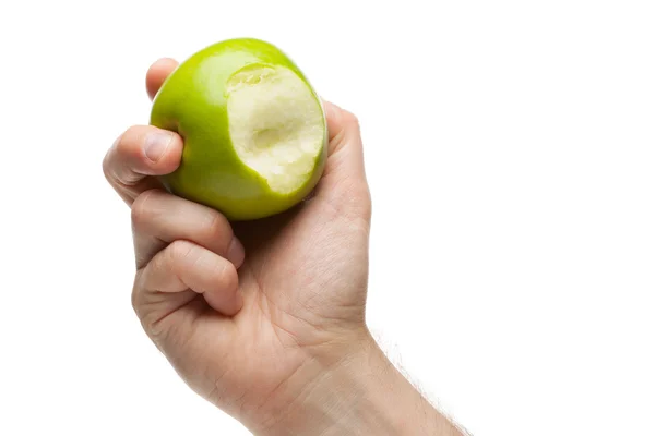 Mano sosteniendo manzana verde con mordida faltante —  Fotos de Stock