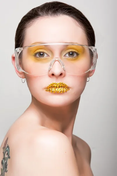 Young caucasian woman with gold fashion makeup — Stock Photo, Image