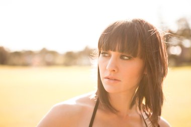 Young caucasian woman in a park with soft summer light clipart