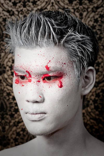 stock image Young asian male with red paint fashion makeup