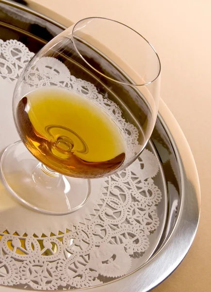 stock image A Glass of Brandy on a Silver Tray