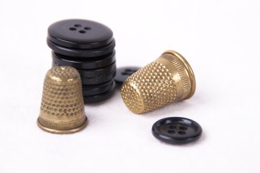 Thimble with needle and buttons clipart