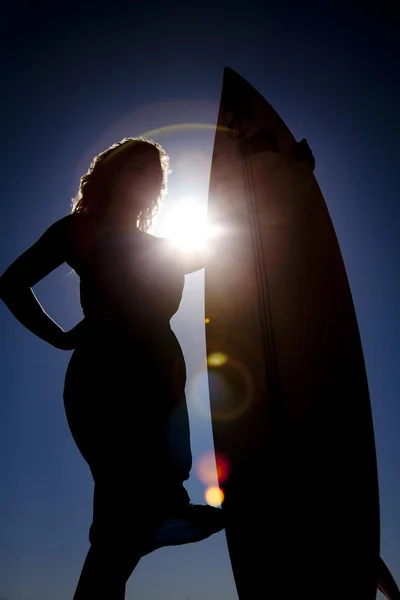 Vrouw surf board zon ringen — Stockfoto