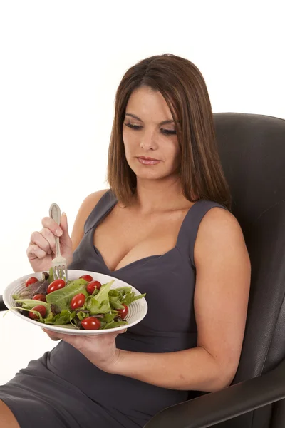 Женщина сидит с тарелкой салата — стоковое фото