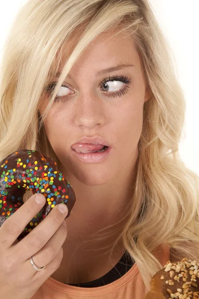 Woman licking by donut — Stock Photo, Image