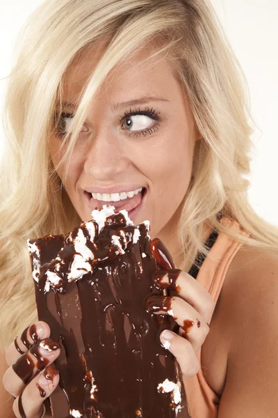 Woman licking chocolate dripping — Stock Photo, Image