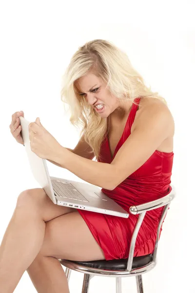 Woman red dress angry with computer — Stock Photo, Image