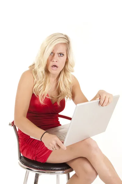 Woman red dress shocked with computer — Stock Photo, Image