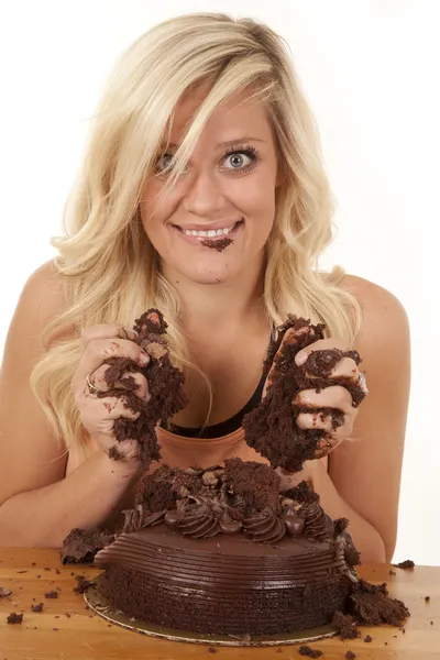 Woman with handfuls of cake smile — Stock Photo, Image