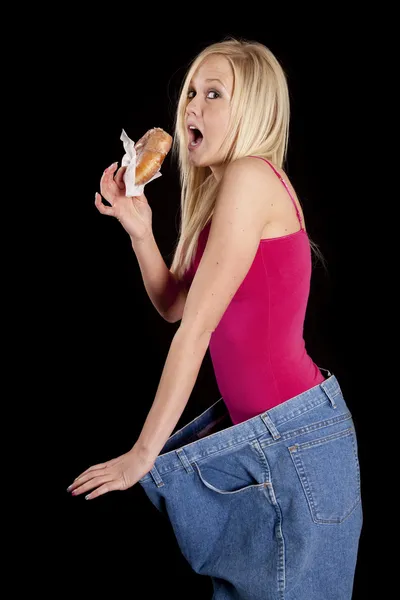 Великі штани пончик їдять — стокове фото