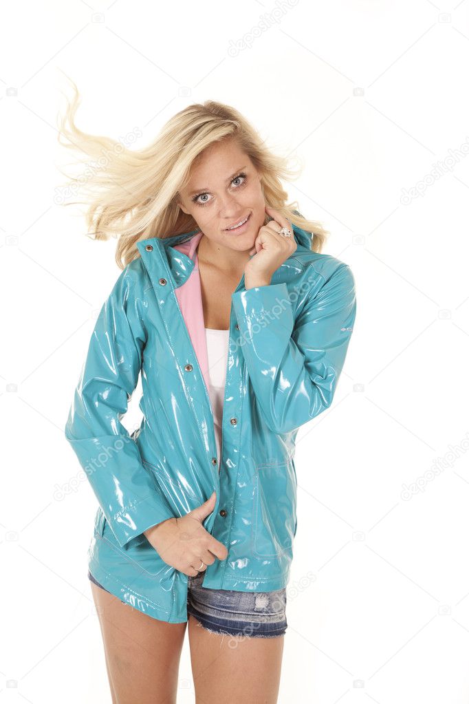Woman in blue rain coat hair blowing